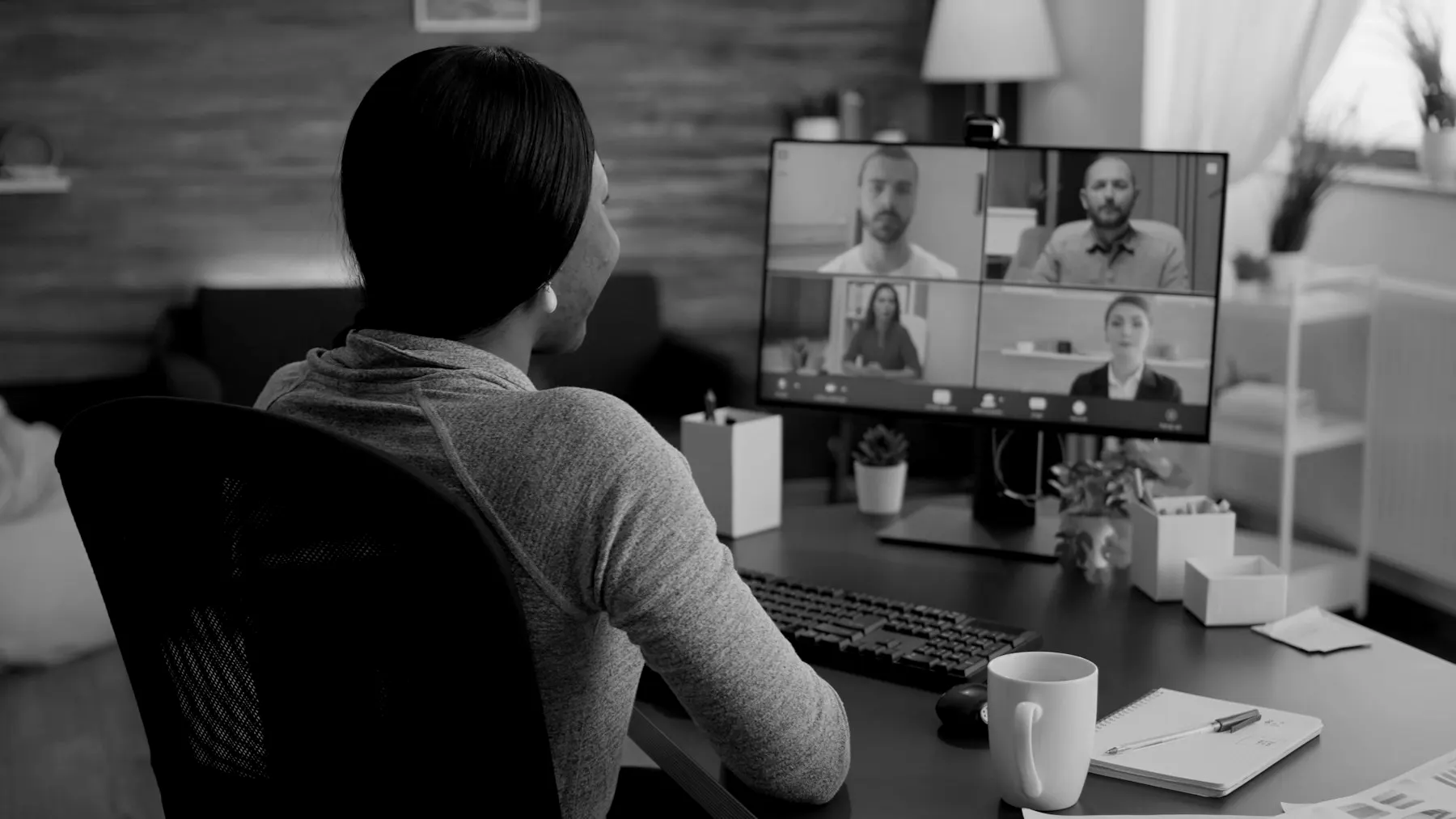 A participant in a live online session with colleagues on screen
